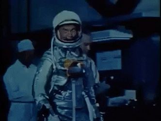 How many Earth orbits did pioneering astronaut John Glenn's first space flight complete?