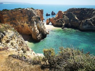 What region in southern Portugal is a popular tourist destination known for its stunning coastline?