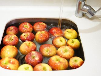 What is the traditional purpose of bobbing for apples on Halloween?