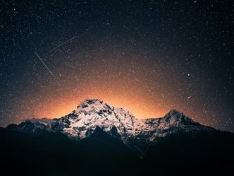 Why do meteors produce light when they enter Earth's atmosphere?