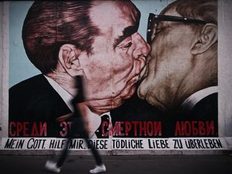 What two leaders are kissing in this Berlin wall graffiti?