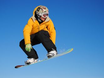 In snowboarding, what does a "triple rodeo" entail?