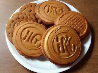 In UK slang, what does 'taking the biscuit' mean?