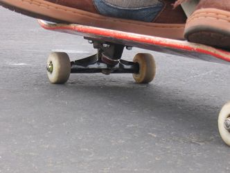 What do you call the part of the skateboard which holds the wheels under the deck?