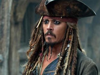 At the age of 15, Johnny Depp dropped out of school in the hopes of becoming what?
