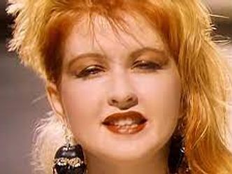 Which WWE Hall of Famer appeared in Cyndi Laupers "Girls Just Wanna Have Fun" music video?