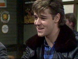 What actor did his first recurrent television role in "Neighbours", in 1987?