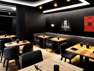 Which restaurant is known for its pitch-black dining experience?